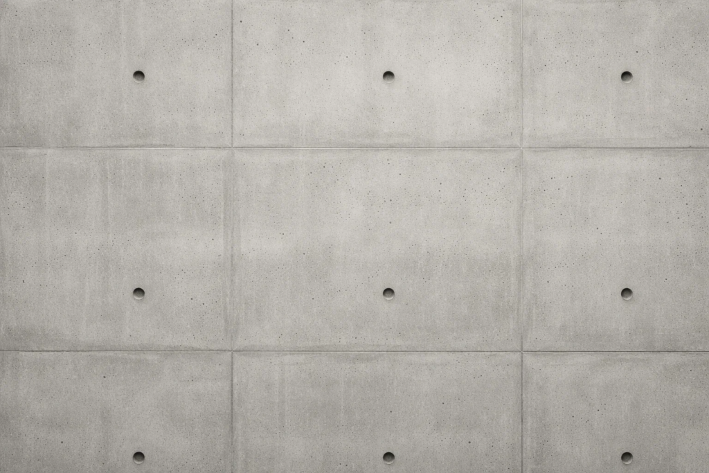 parede de concreto aparente com marcas sutis do molde, formando o efeito conhecido como fantasma de fôrma